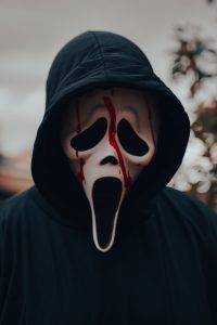 a person in a ghostface mask