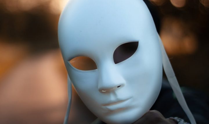 focus photography of white mask