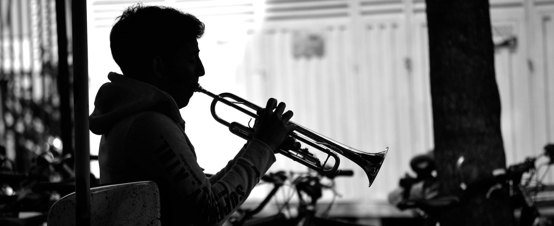 silhouette of man playing trumpet