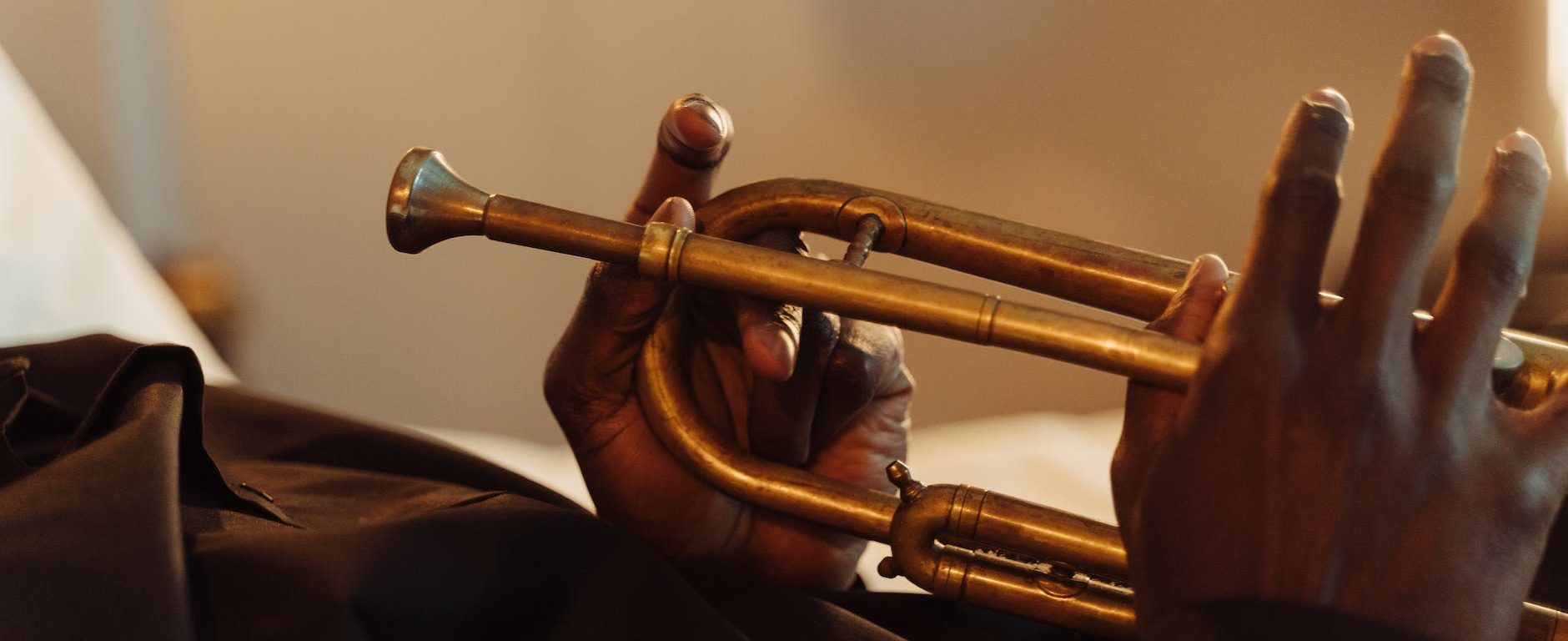 close up of a person holding a trumpet