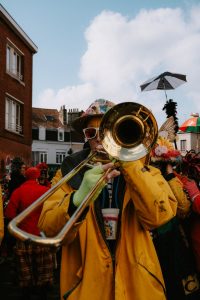 man playing the trombone at a parade