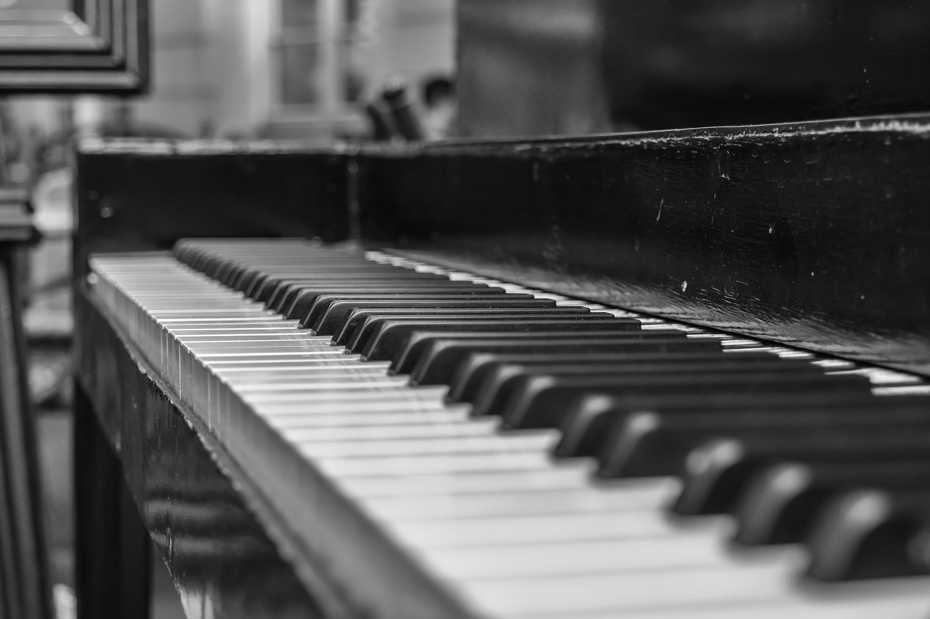 close up shot of upright piano grayscale photo. Equal temperament largely dealt with tuning and intonation.